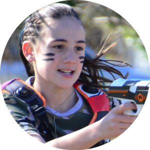 Girls Birthday Party - Laser Tag is a great idea for Outdoor Birthday Parties. This Girl has war stripes on her face and shows her aiming her laser tag blaster.