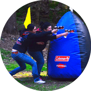 Two adults teaming up for an assault at a Team Building Exercise
